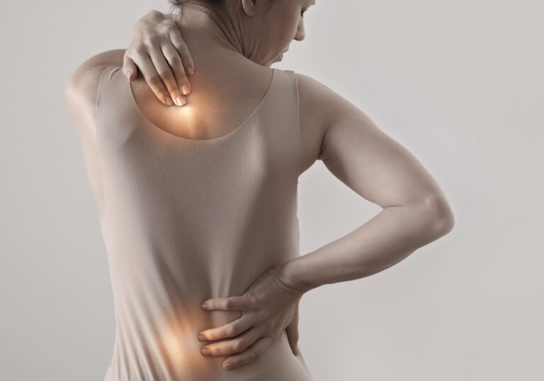 woman suffering from back pain spinal decompression McKinney Texas